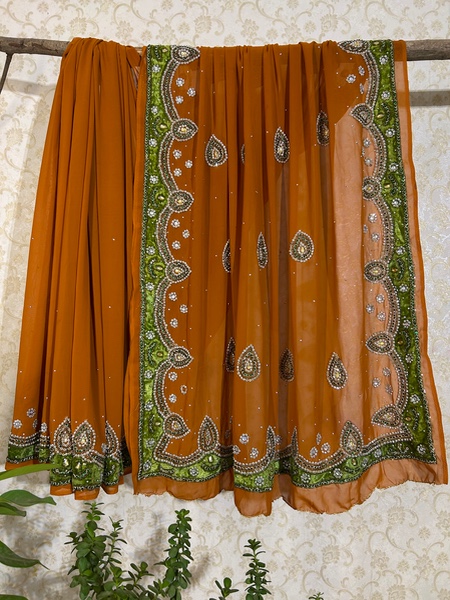 Rust with green velvet border saree